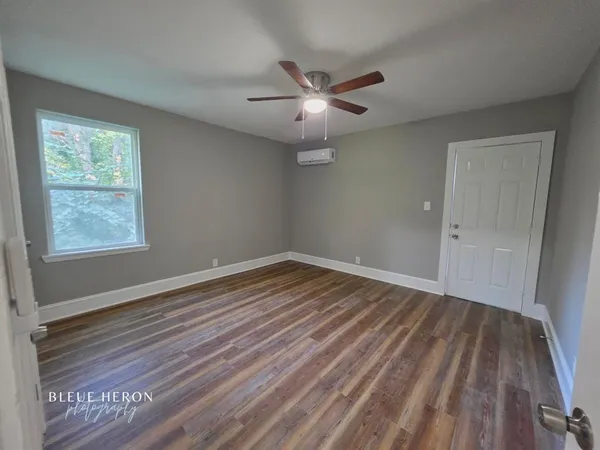 wooden floor in an empty room with a window