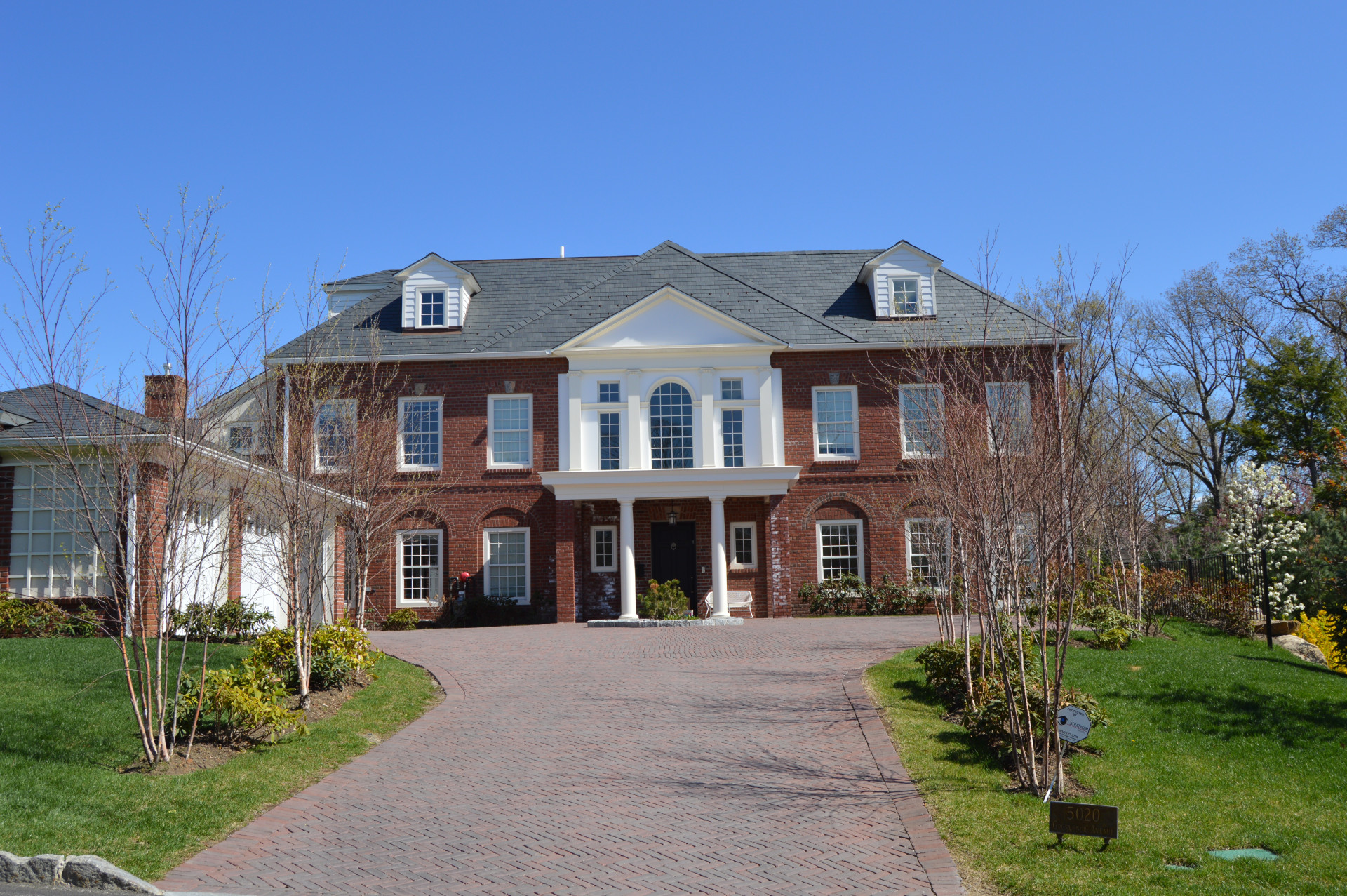 a front view of a house with garden