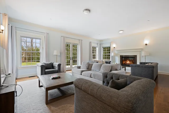 a living room with furniture fireplace and a table