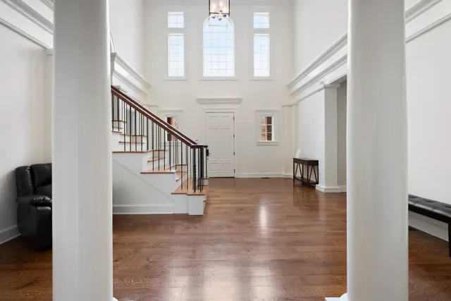 a view of entryway and hall with wooden floor
