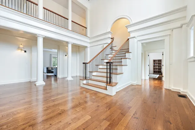 a view of entryway and hall with wooden floor