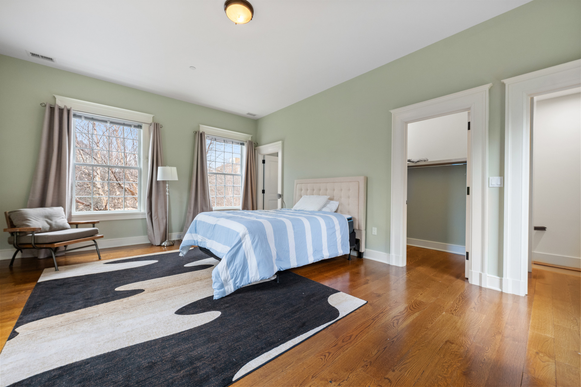 5020 Grosvenor Avenue, Unit 1 Bronx, NY 10471 - Photo 24 of 32 a bedroom with a bed and wooden floor
