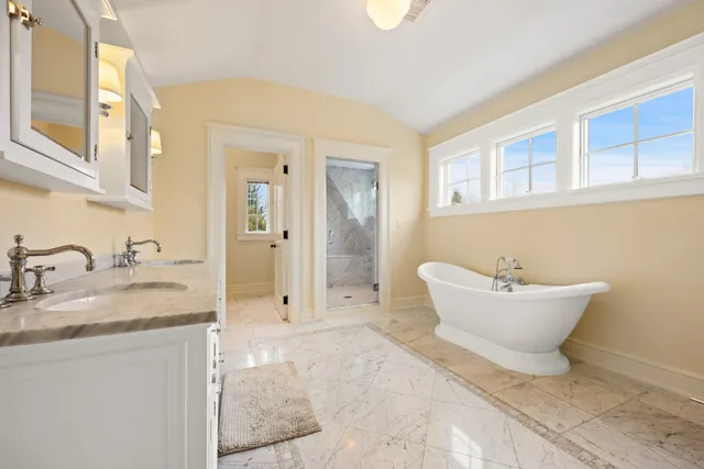 a bathroom with a granite countertop sink and mirror