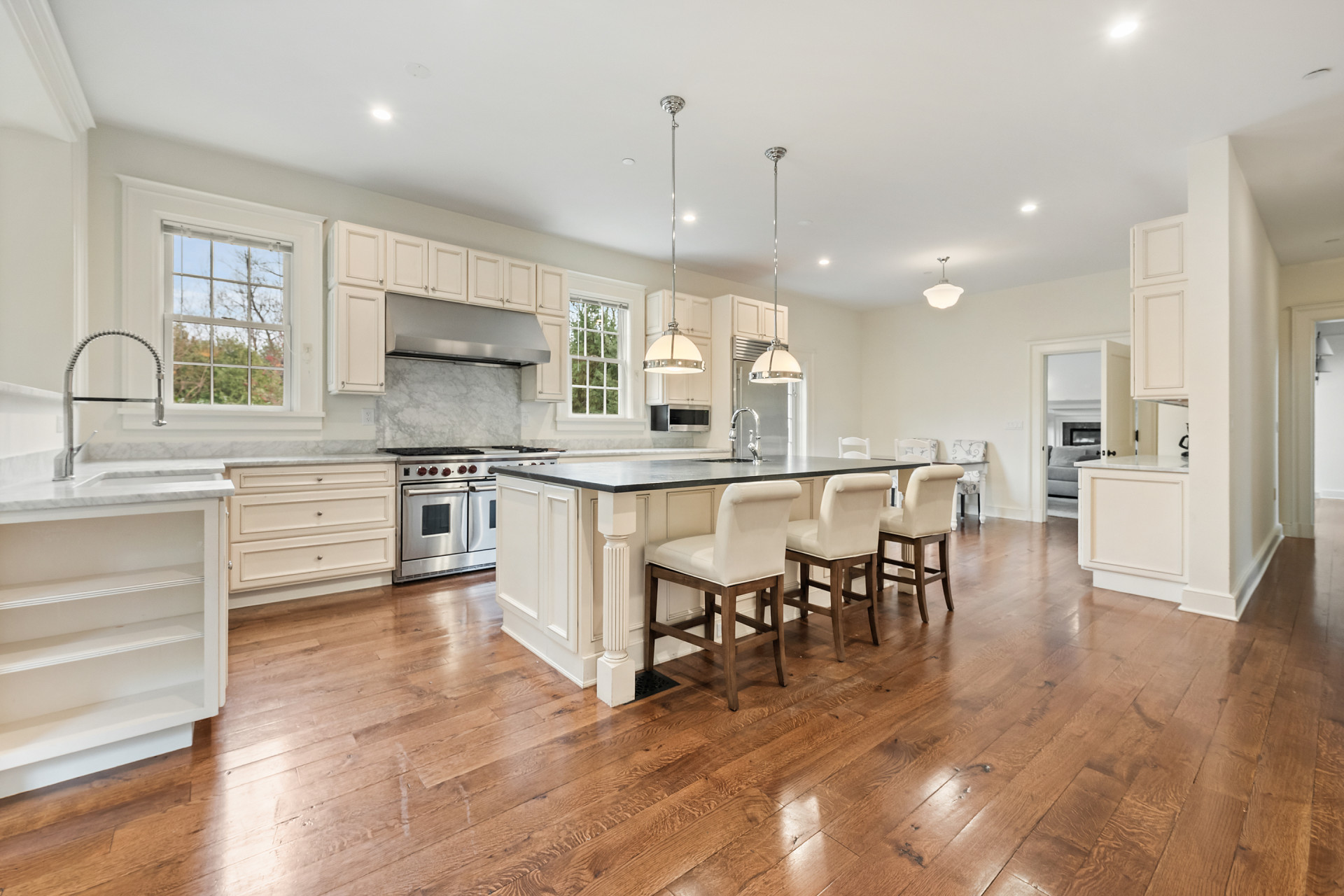 5020 Grosvenor Avenue, Unit 1 Bronx, NY 10471 - Photo 10 of 32 a large kitchen with cabinets chairs and wooden floor