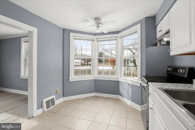 a kitchen with cabinets appliances a sink and a counter space