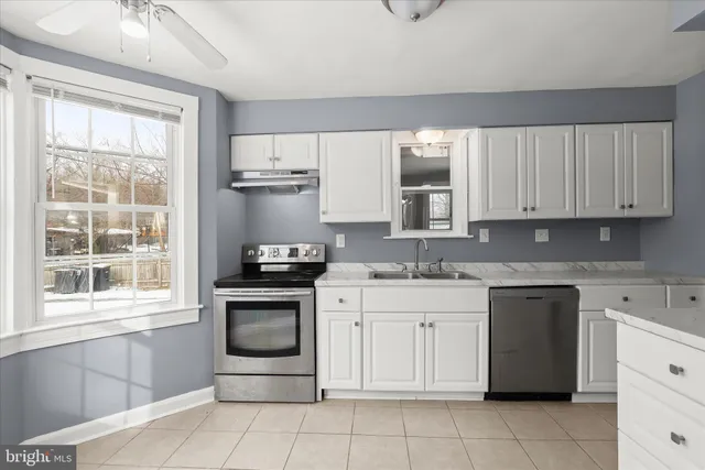 a white toilet sitting next to a bathroom sink