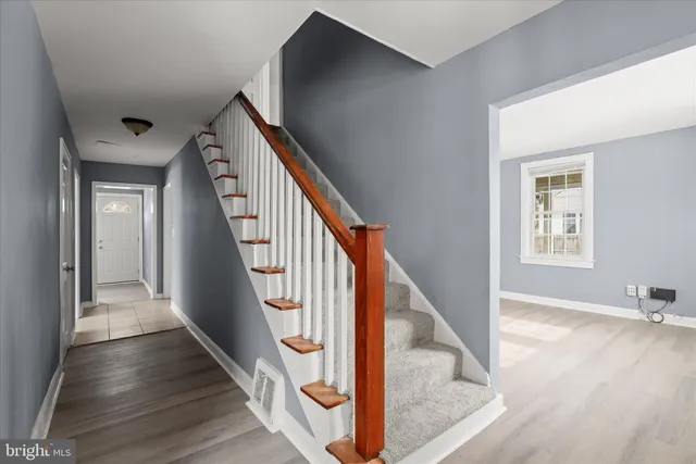 a view of entryway and hall with wooden floor