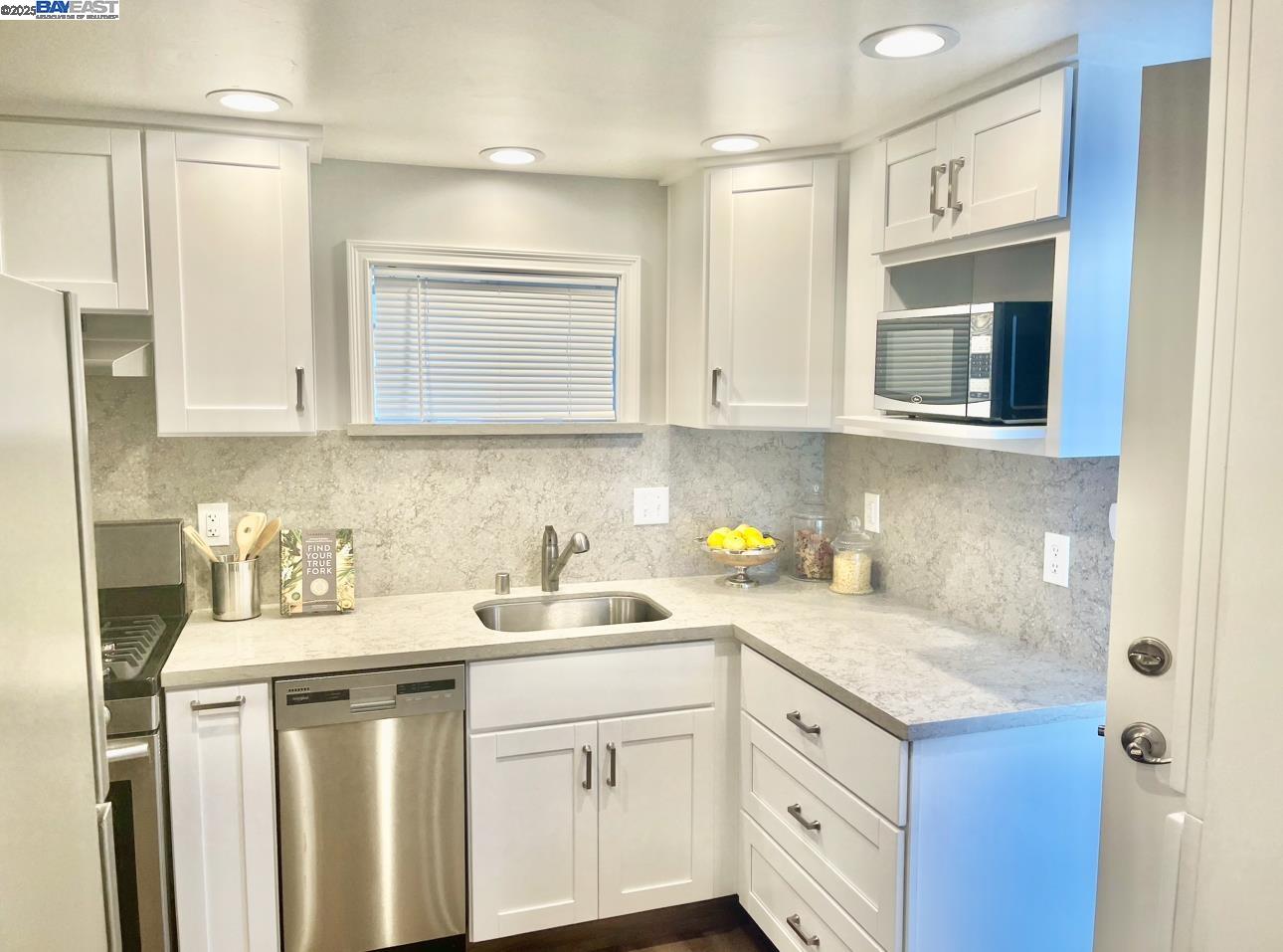 37230 2nd Street Fremont, CA 94536 - Photo 19 of 49 a kitchen with stainless steel appliances granite countertop white cabinets sink and dishwasher
