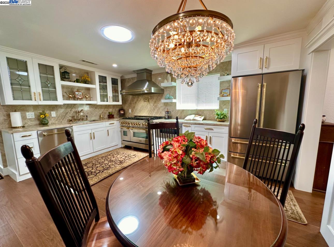 37230 2nd Street Fremont, CA 94536 - Photo 3 of 49 a dining room with wooden floor a chandelier a wooden table and chairs