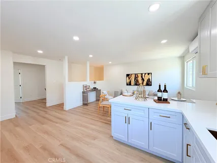 a kitchen with a sink and wooden floor