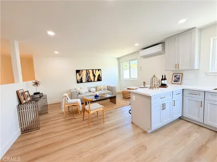 a large white kitchen with sink and white cabinets