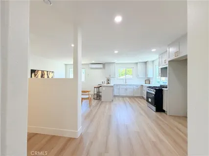 a kitchen with stainless steel appliances a refrigerator and a stove top oven