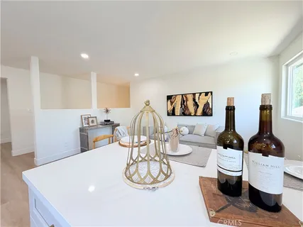 a living room with hard wood flooring furniture and a table
