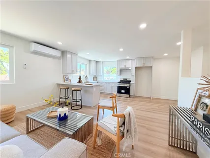 a living room with furniture and kitchen view