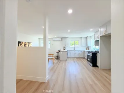 a kitchen with stainless steel appliances a refrigerator and a stove top oven