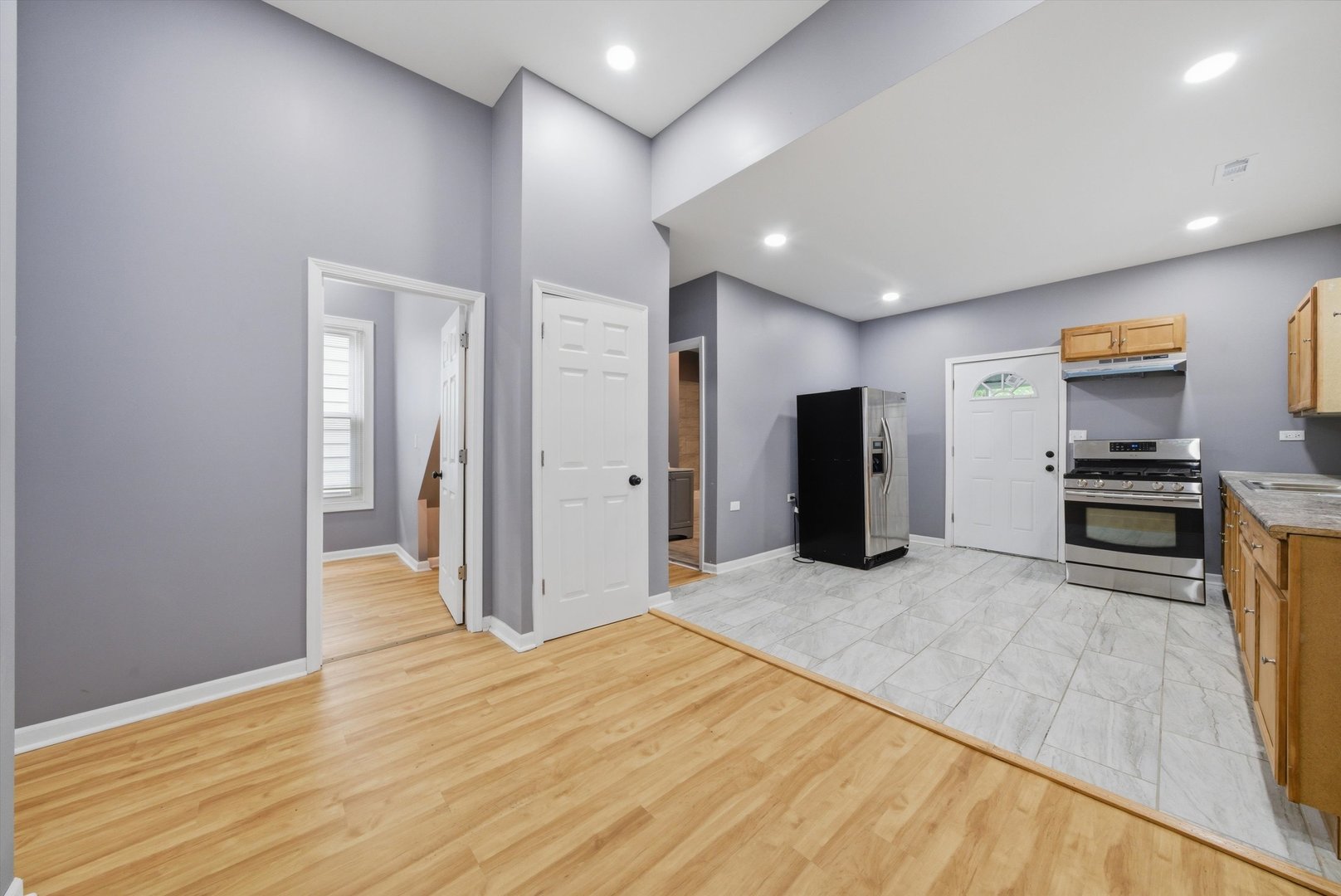 7828 South Escanaba Avenue Chicago, IL 60649 - Photo 13 of 41 a view of a kitchen with refrigerator and wooden floor