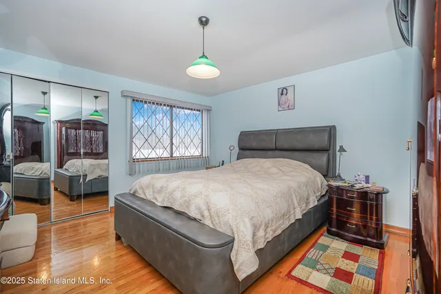 a bed room with a bed and a chandelier