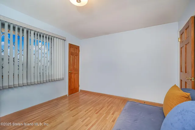 a view of a room with wooden floor and a window