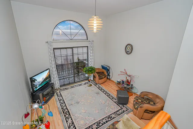 a living room with furniture a rug and a window