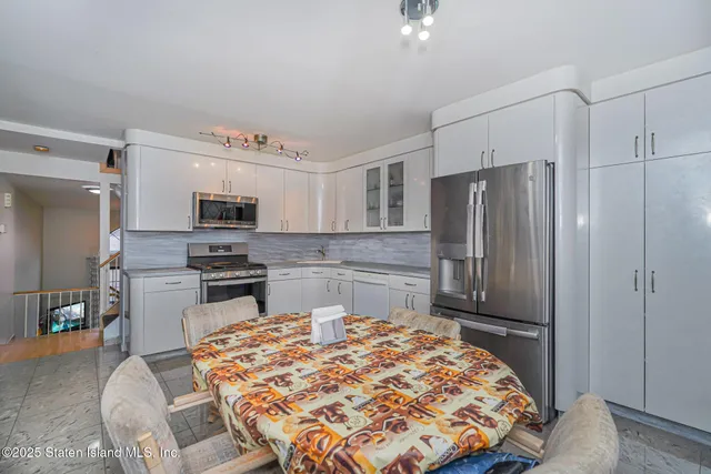 a kitchen with stainless steel appliances a refrigerator and stove