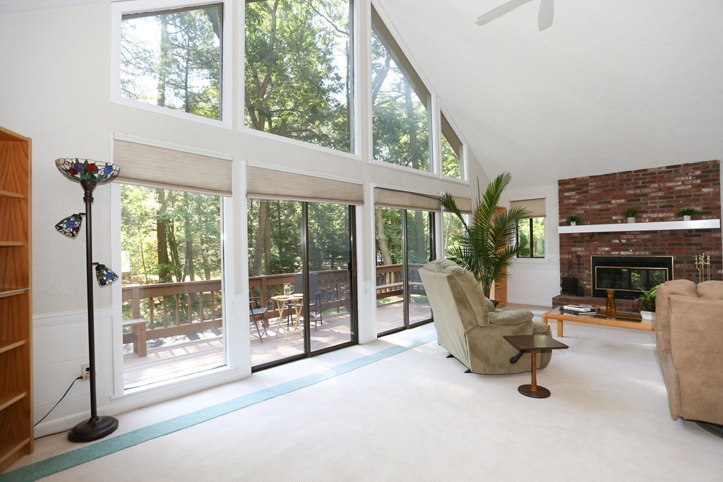 96 Stock Farm Road Sudbury, MA 01776 - Photo 13 of 30 a living room with furniture a floor to ceiling window and potted plants