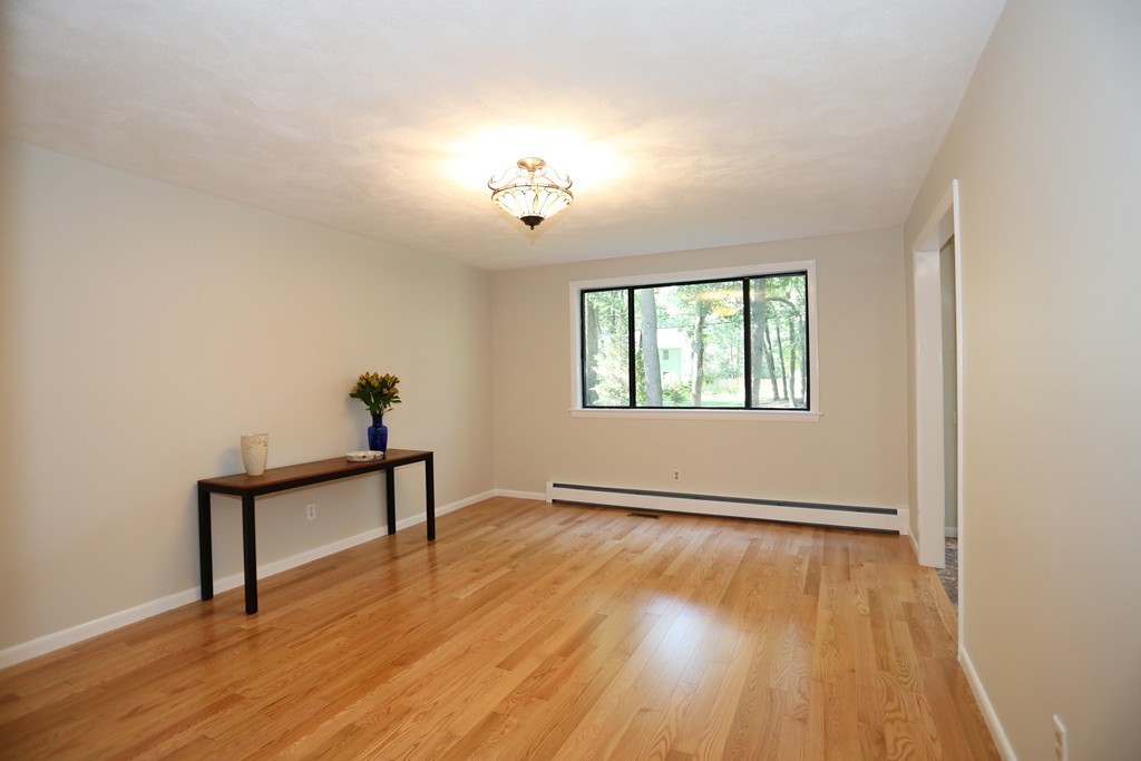 96 Stock Farm Road Sudbury, MA 01776 - Photo 15 of 30 wooden floor in an empty room with a window