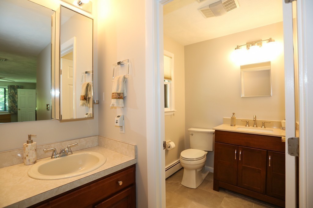 96 Stock Farm Road Sudbury, MA 01776 - Photo 20 of 30 a spacious bathroom with a granite countertop sink toilet a large mirror a shower and a mirror