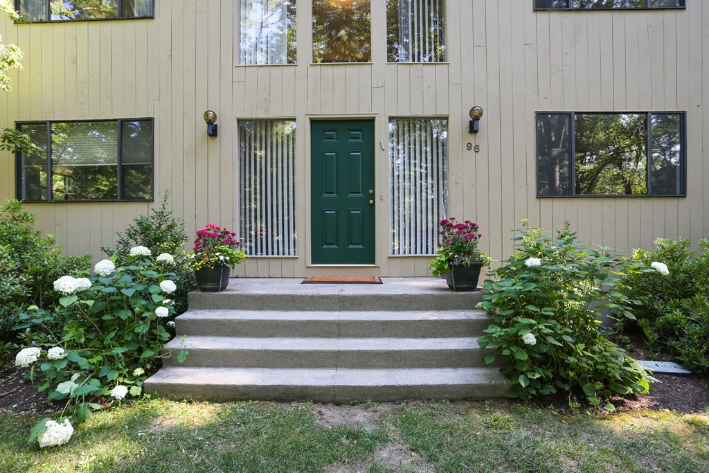96 Stock Farm Road Sudbury, MA 01776 - Photo 2 of 30 a front view of a house with plants and flowers