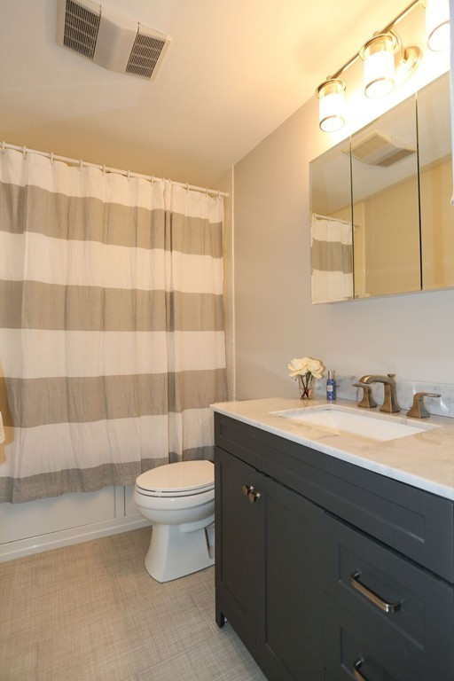 96 Stock Farm Road Sudbury, MA 01776 - Photo 23 of 30 a bathroom with a granite countertop sink a toilet and a mirror
