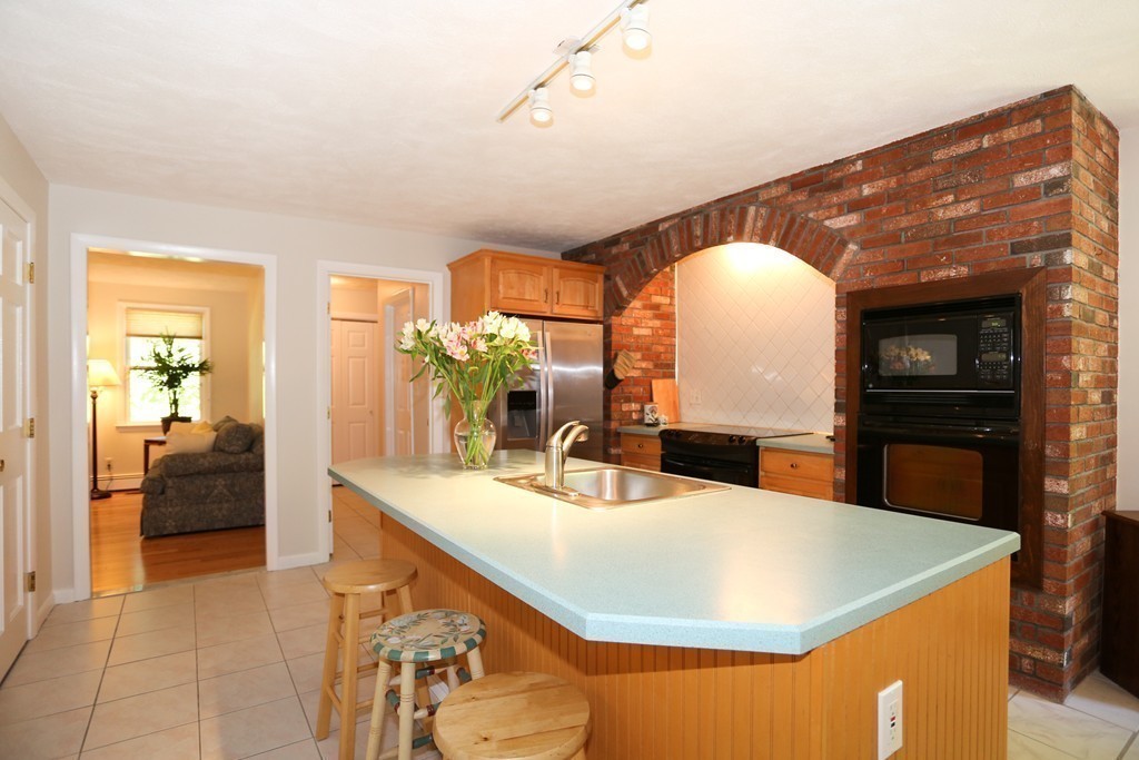 96 Stock Farm Road Sudbury, MA 01776 - Photo 8 of 30 a kitchen with kitchen island a sink and a refrigerator