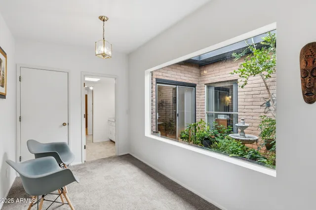 a bedroom with a bed couch and a window