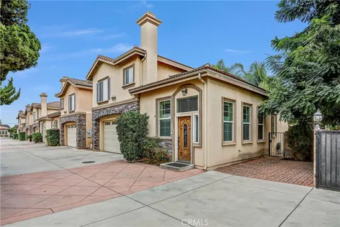 a front view of a house with a yard and trees