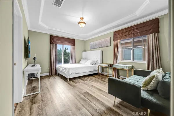 a bedroom with a bed and a couch next to a window