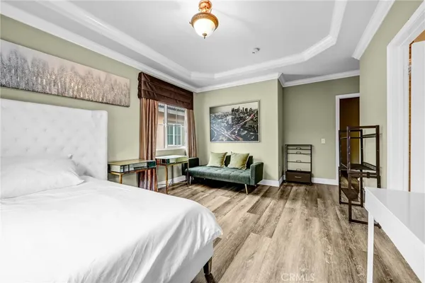 a bedroom with a bed couch and a window