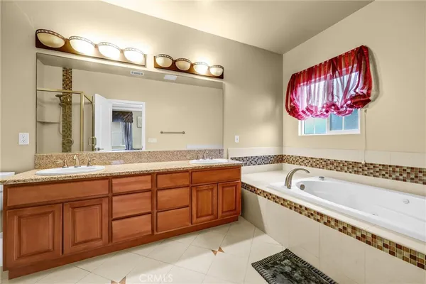 a spacious bathroom with a granite countertop tub sink and mirror