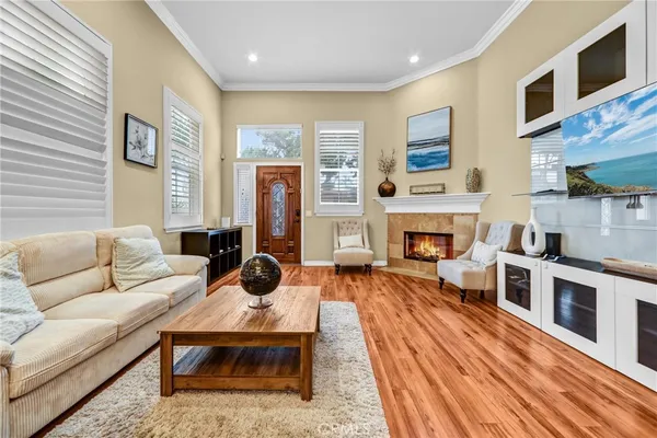 a living room with furniture a fireplace and a flat screen tv