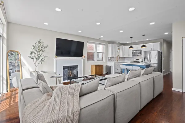a living room with furniture a fireplace and a flat screen tv
