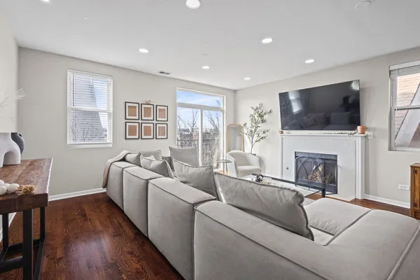 a living room with furniture a fireplace and a flat screen tv
