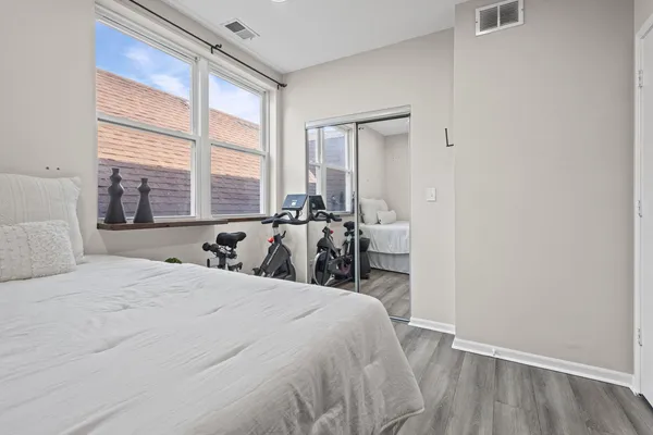 a bed sitting in a bedroom next to a window