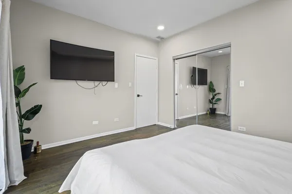 a bedroom with a bed and a flat screen tv