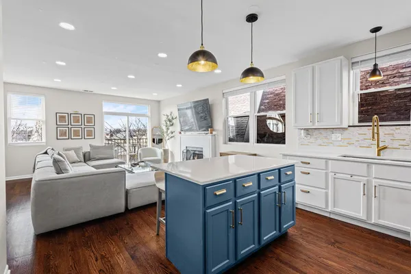 a kitchen with center island and stainless steel appliances