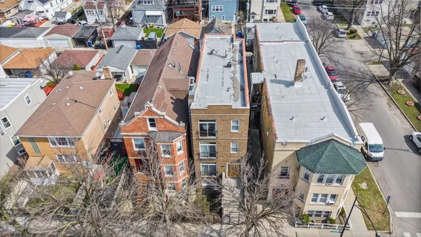 an aerial view of residential houses with outdoor space