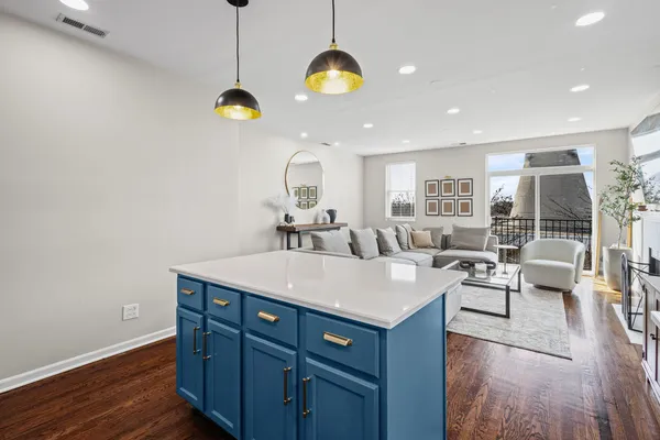 a room with a sink cabinets and wooden floor