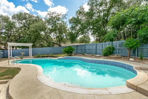a swimming pool with outdoor seating and yard