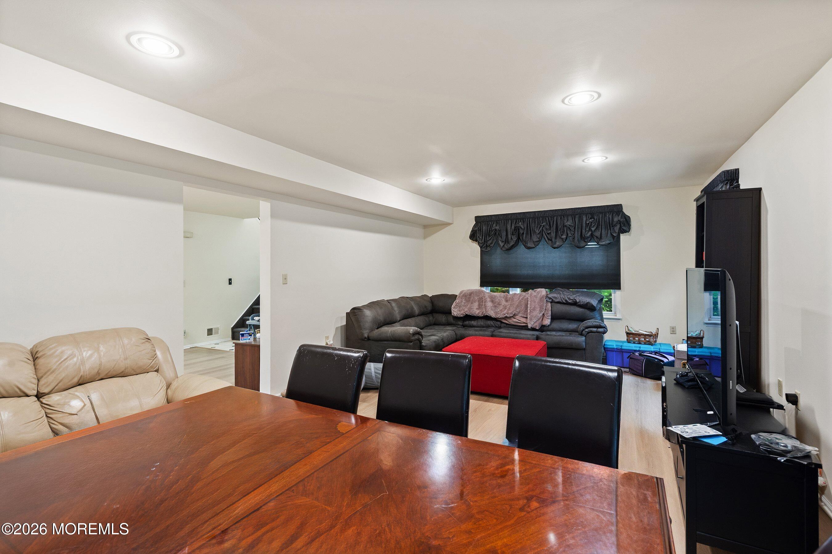 47 Sweet Gum Road Howell, NJ 07731 - Photo 5 of 27 a living room with furniture a flat screen tv and a refrigerator