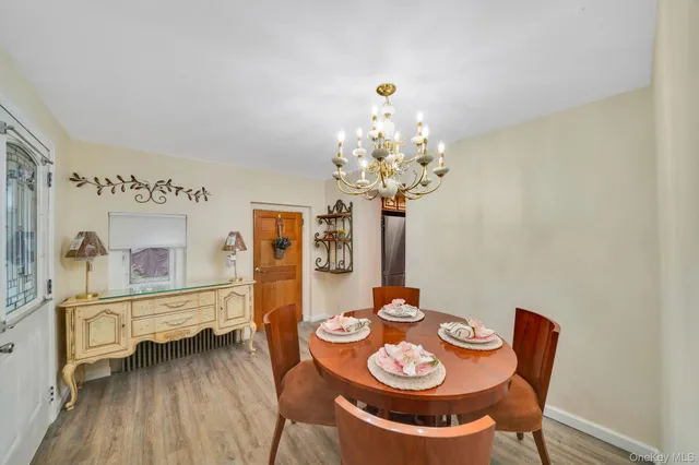 a dining room with furniture and wooden floor