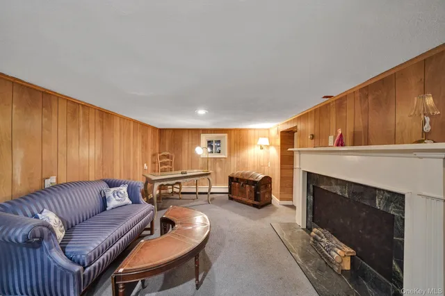a living room with furniture a flat screen tv and a table