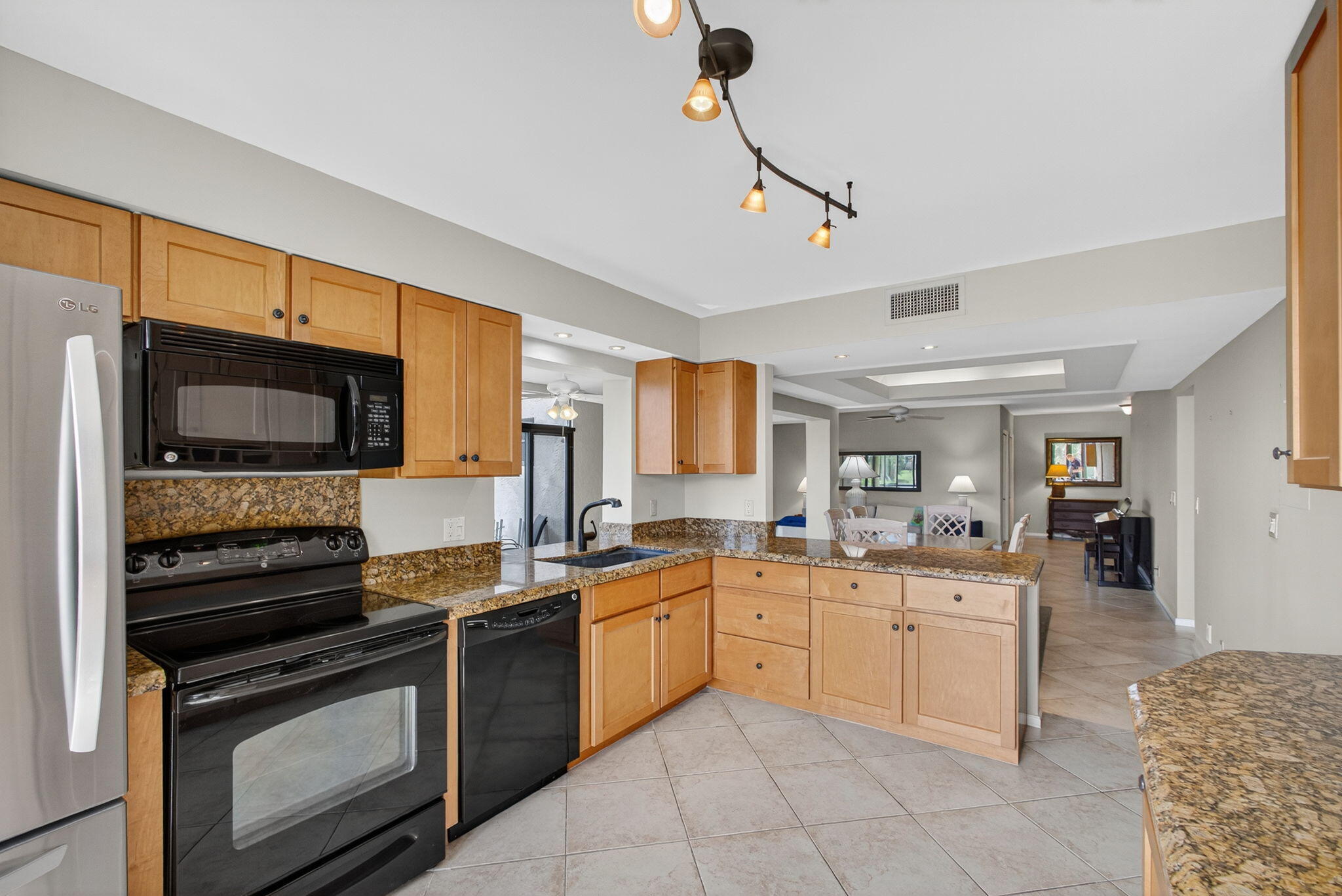 16885 Waterbend Drive, Unit 175 Jupiter, FL 33477 - Photo 17 of 43 a kitchen with a sink stove and microwave