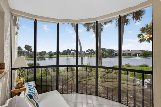 a living room with furniture a rug and kitchen view