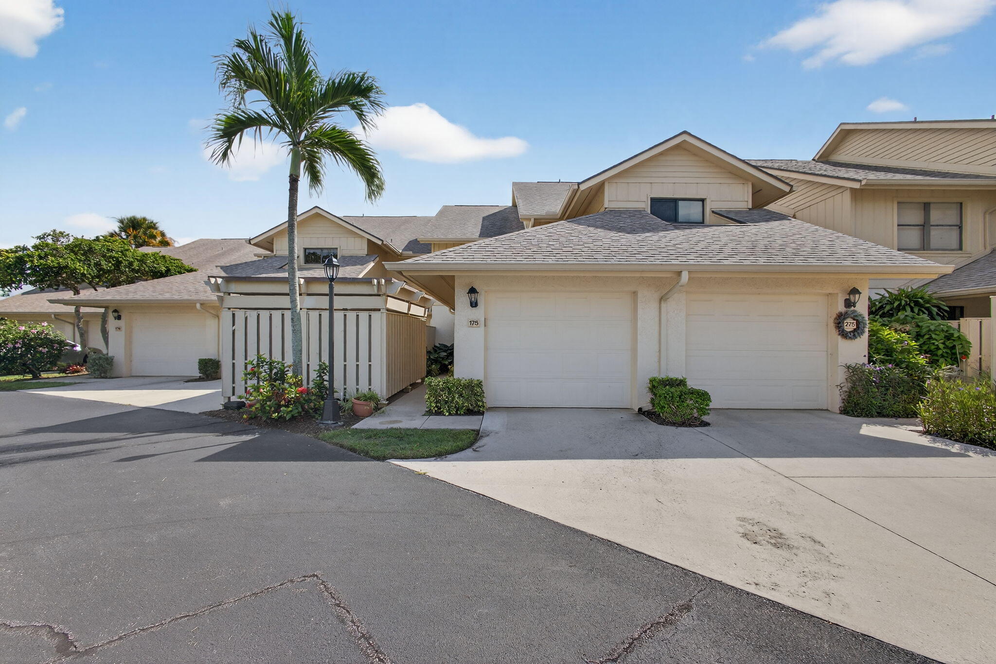 16885 Waterbend Drive, Unit 175 Jupiter, FL 33477 - Photo 2 of 43 a front view of a house with a yard and garage